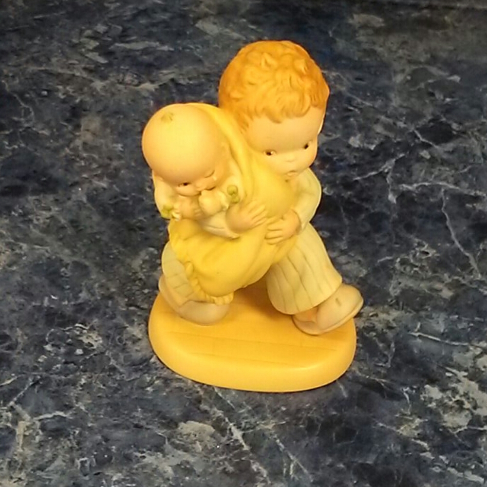 God bless em statue